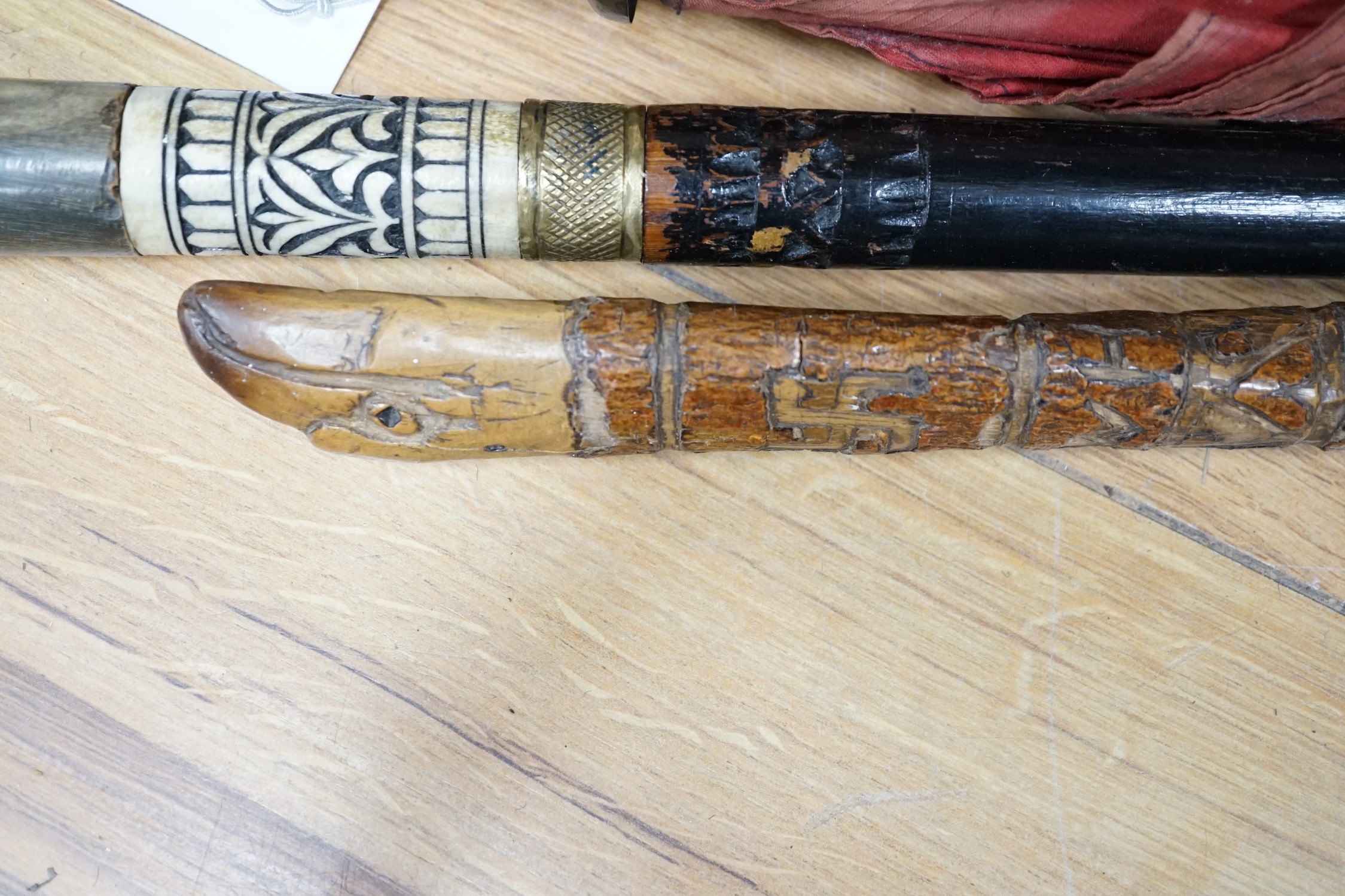 A bone and brass mounted ebonised sword stick, a Chinese umbrella and a cane